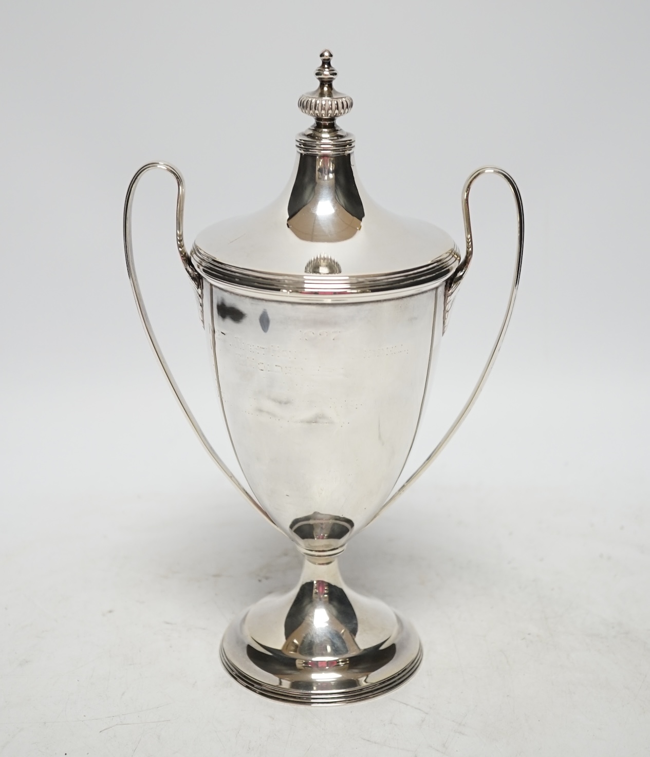 A George V silver two handled urn shaped cup and cover, Goldsmiths & Silversmiths Co Ltd, London, 1922, 23.5cm, 9.8oz. Fair condition.